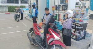 PTT staff member filling up motorcycle with fuel